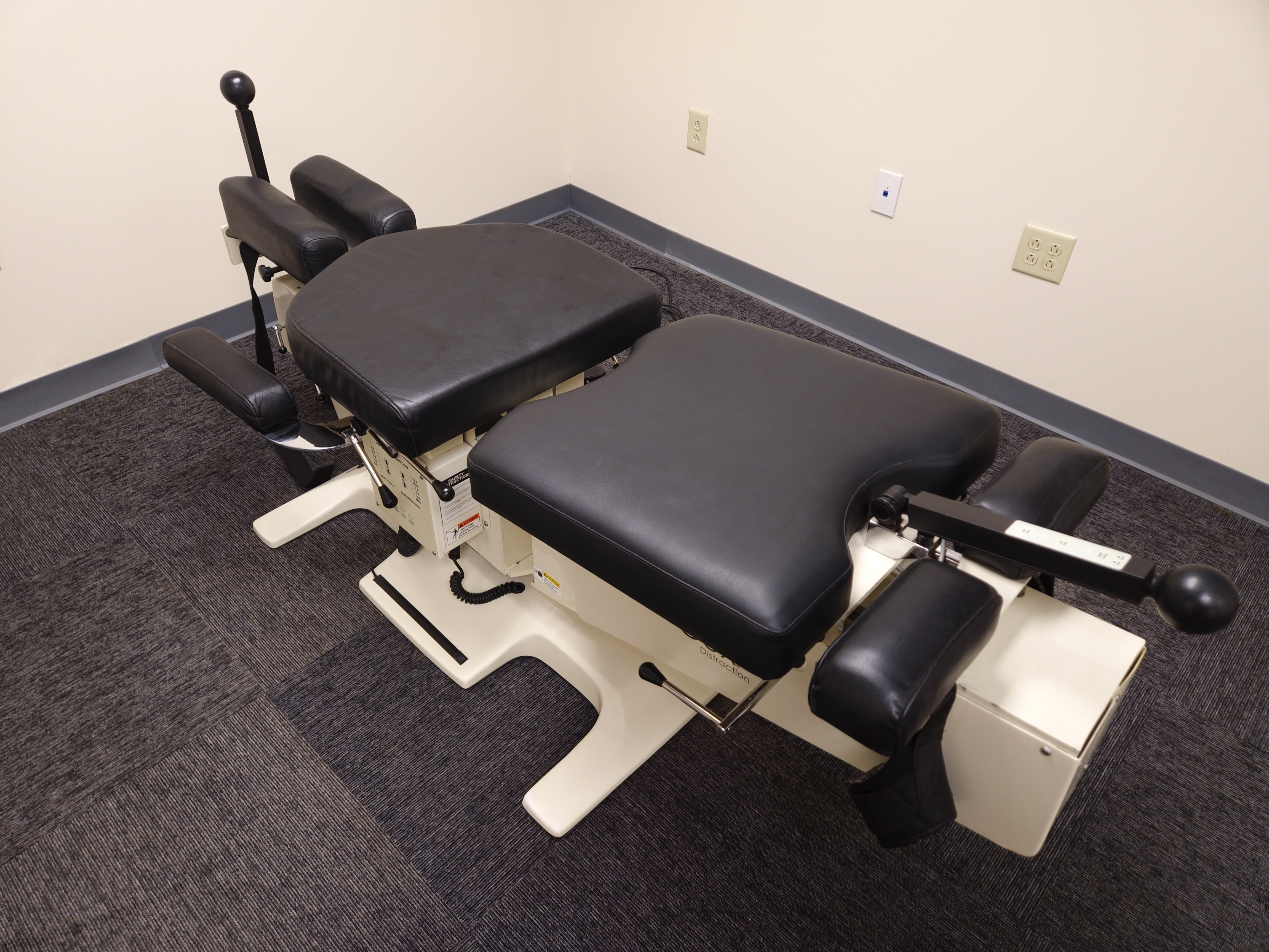 An image of a COX flexion adjustment table is show in black.
