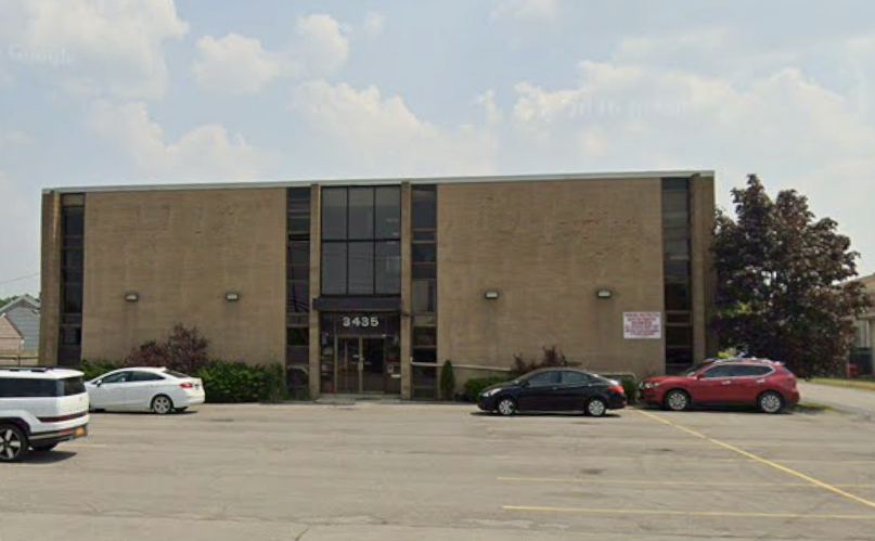 An office building is shown from the street.