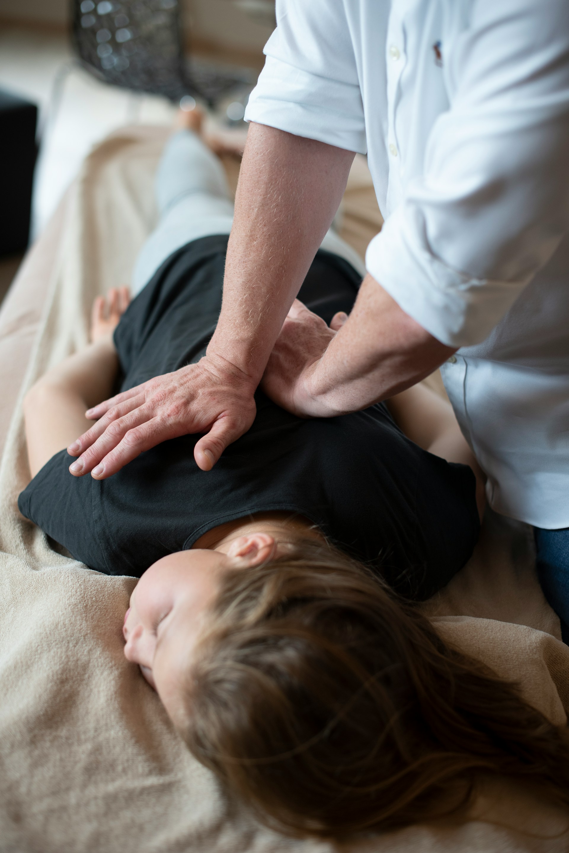 An image is shwon with a person being adjusted on a drop-table.